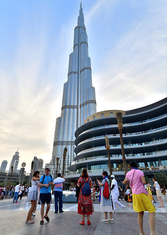 Dubai, UAE - April 8. 2018. Tourists in the square in front of the Burj Khalifa and Dubai Mall